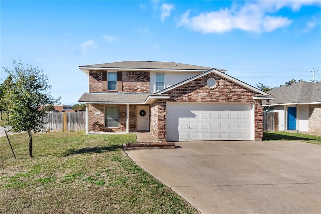 view of property featuring a front yard and a garage