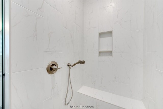 bathroom with a tile shower