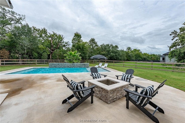 view of pool with a fire pit, a patio area, and a yard