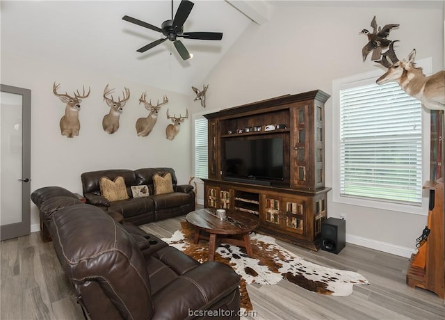 living room featuring ceiling fan, beam ceiling, dark wood-type flooring, and high vaulted ceiling