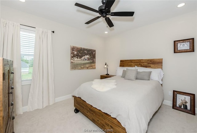 carpeted bedroom with ceiling fan and multiple windows