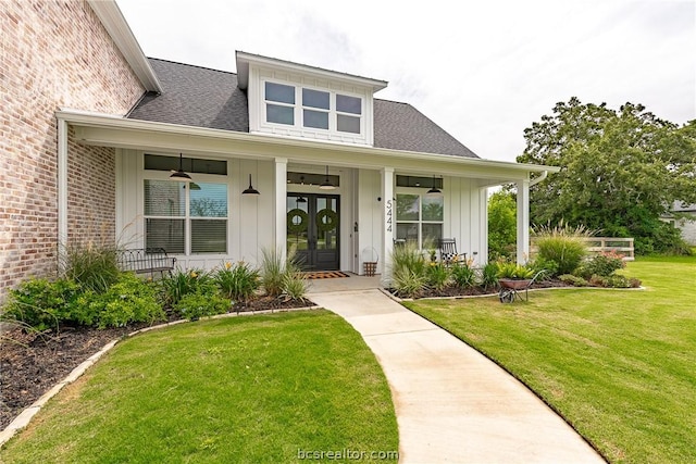 doorway to property with a yard and french doors