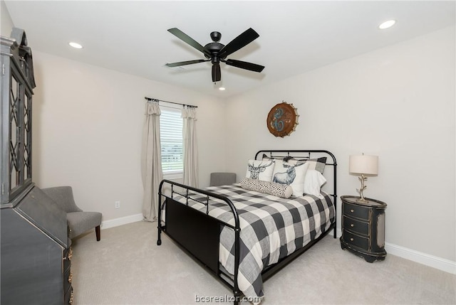 bedroom featuring light colored carpet and ceiling fan