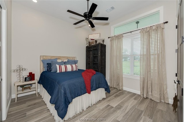 bedroom with hardwood / wood-style flooring and ceiling fan