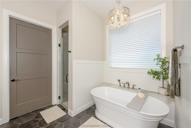 bathroom with shower with separate bathtub, an inviting chandelier, and tile patterned floors