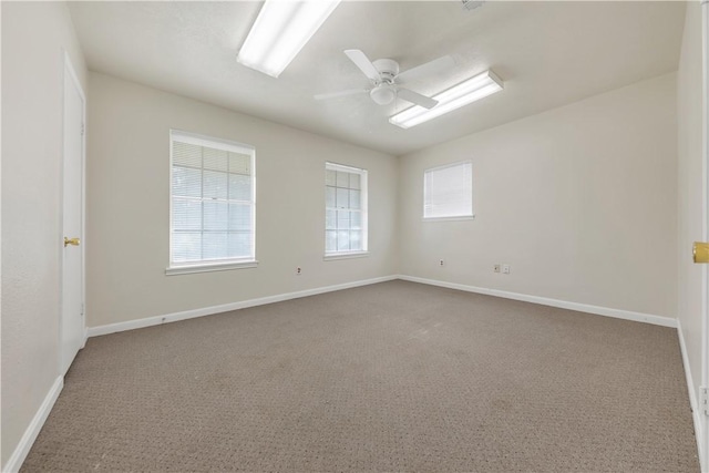 carpeted empty room featuring ceiling fan