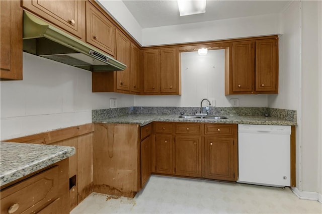 kitchen with white dishwasher, light stone counters, and sink