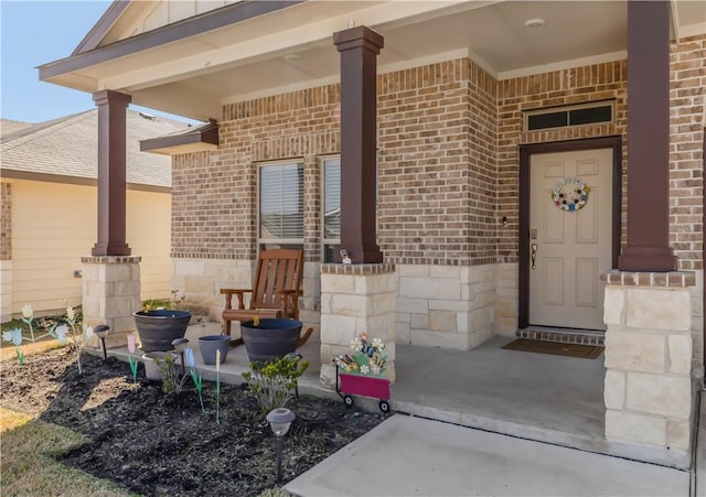 view of exterior entry with a porch