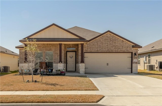 craftsman inspired home featuring central air condition unit and a garage