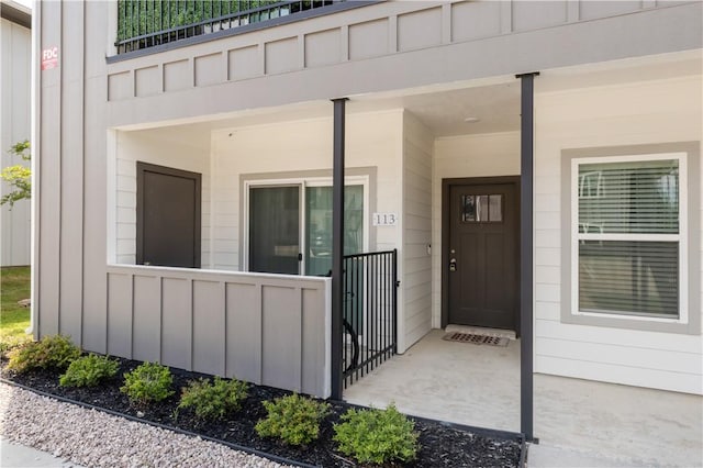 1326 Prairie Dr Unit 113, Bryan, TX 77803 - doorway to property with board and batten siding and a porch
