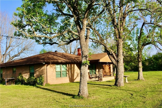 rear view of house featuring a yard and a patio