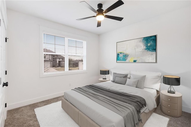 carpeted bedroom featuring baseboards and a ceiling fan