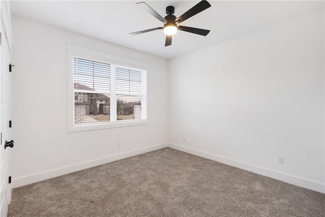 carpeted empty room with ceiling fan and baseboards