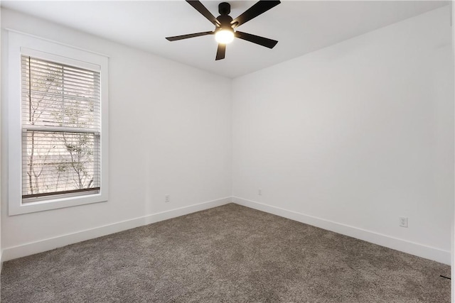 carpeted empty room featuring a ceiling fan and baseboards