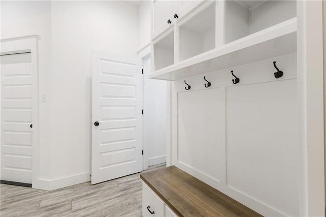 mudroom with light wood-type flooring and baseboards