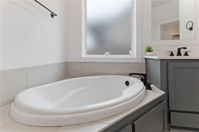 bathroom featuring a bath and vanity