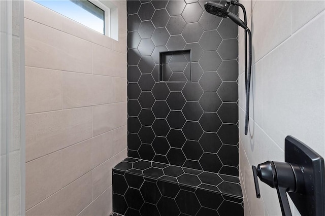 interior details featuring a tile shower