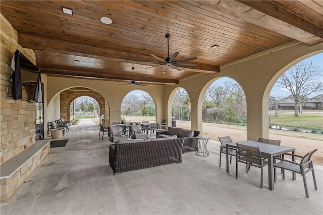 view of patio with outdoor dining area, an outdoor living space, and a ceiling fan