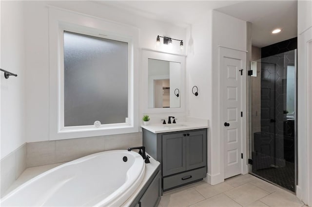 full bathroom with a bathing tub, a shower stall, vanity, and tile patterned floors