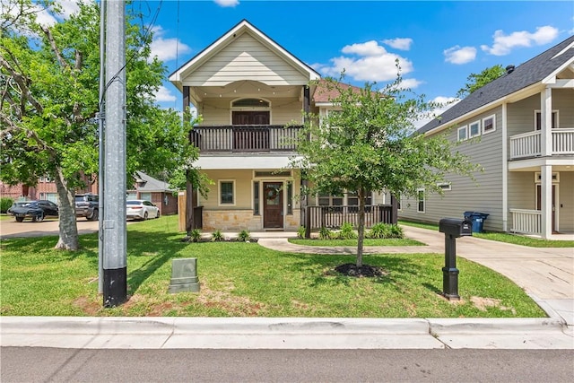 1611 Park Pl, College Station, TX 77840 - view of front of property with a balcony, covered porch, and a front lawn
