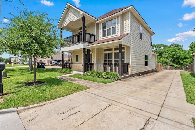 1611 Park Pl, College Station, TX 77840 - view of front of house featuring a balcony, covered porch, driveway, and roof with shingles