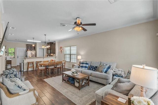 1611 Park Pl, College Station, TX 77840 - living room with ceiling fan, ornamental molding, dark wood-type flooring, and a chandelier