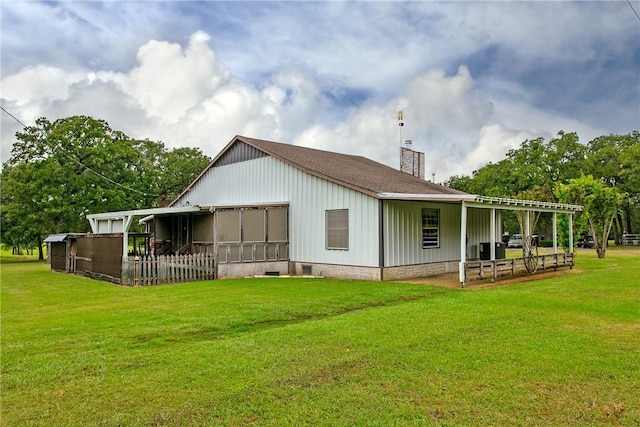 rear view of house with a lawn