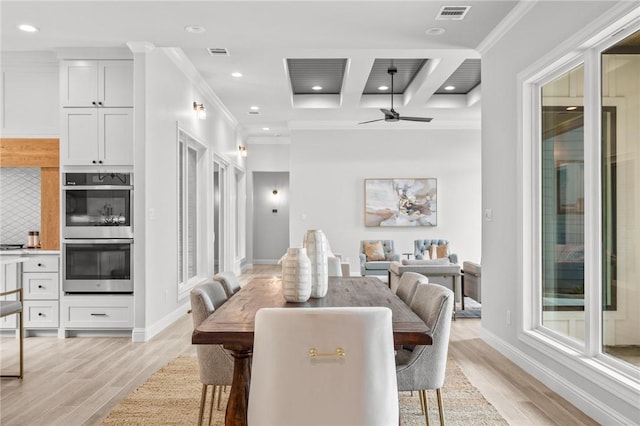 dining room with ceiling fan, light hardwood / wood-style floors, coffered ceiling, and ornamental molding