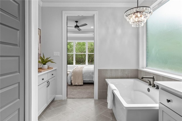 bathroom with tile patterned flooring, vanity, ornamental molding, and a wealth of natural light