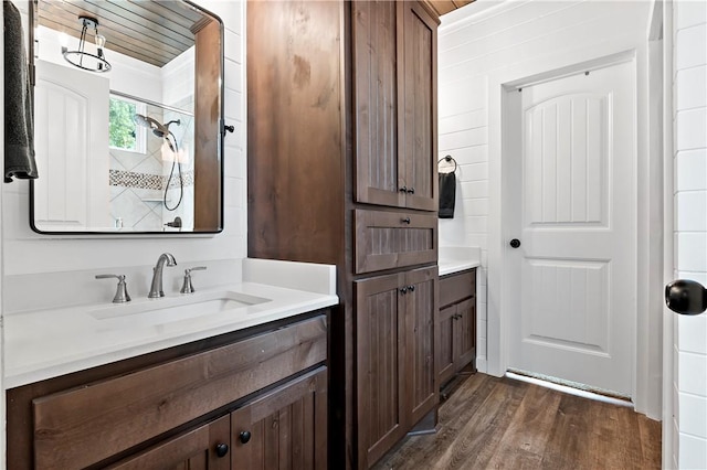 full bath with a shower, wood finished floors, and vanity
