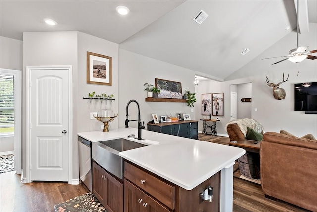 kitchen featuring open floor plan, dishwasher, dark wood finished floors, and a sink