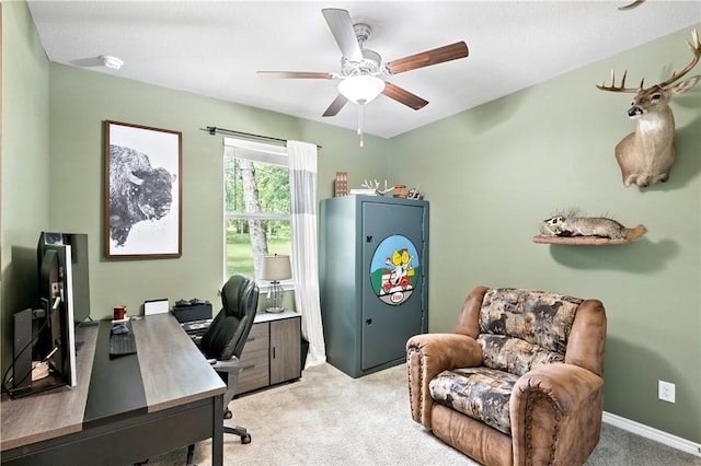 office space featuring a ceiling fan and light colored carpet