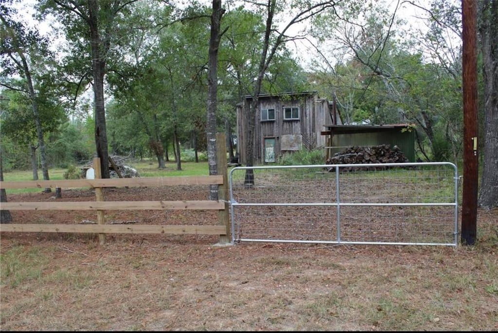 view of gate featuring an outbuilding