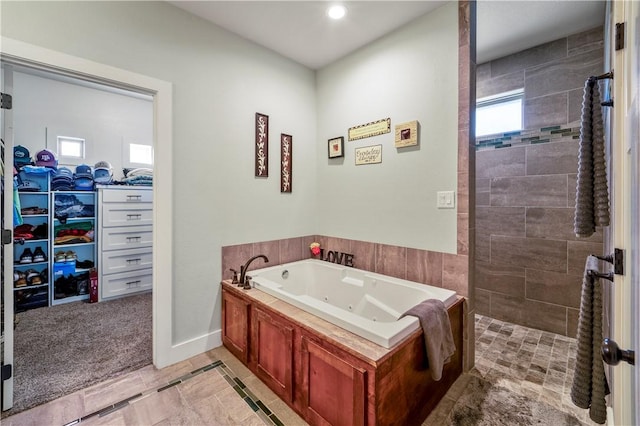 bathroom featuring independent shower and bath and tile patterned flooring