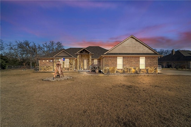 view of front facade featuring a yard and brick siding