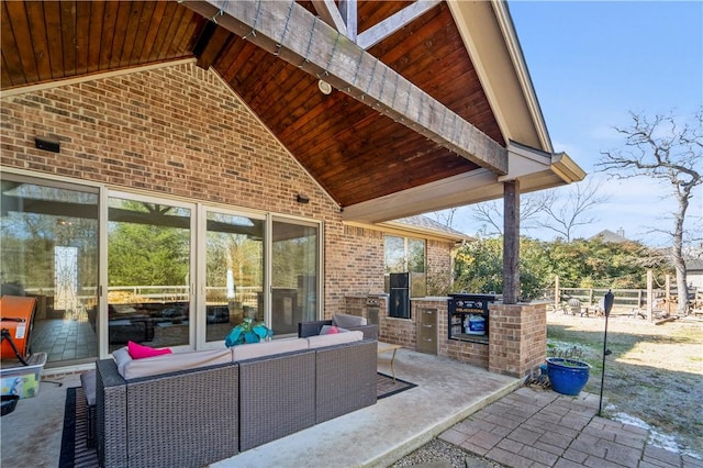 view of patio featuring an outdoor living space and an outdoor kitchen