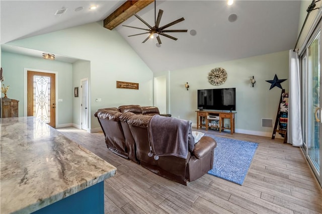 living room featuring ceiling fan and vaulted ceiling with beams