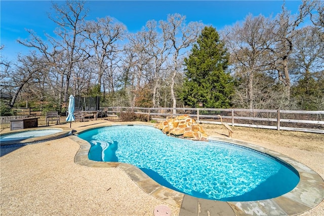 view of pool featuring an in ground hot tub, a patio area, and a trampoline