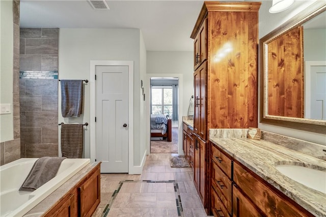 bathroom featuring vanity and a tub