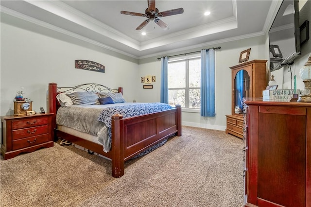 bedroom featuring crown molding, carpet, ceiling fan, and a tray ceiling