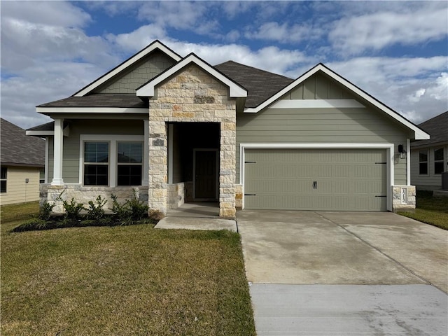 craftsman house with board and batten siding, a garage, stone siding, driveway, and a front lawn