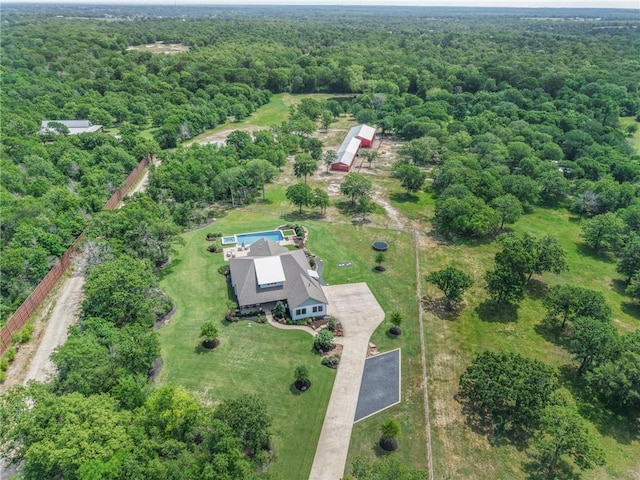 birds eye view of property featuring a view of trees