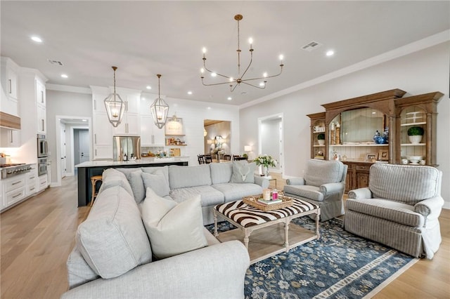 living room featuring recessed lighting, visible vents, light wood finished floors, and an inviting chandelier