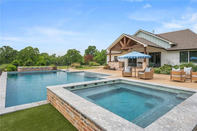 outdoor pool featuring an outdoor hangout area, a patio area, and an in ground hot tub