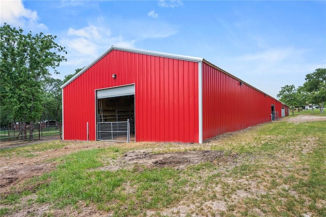 view of pole building featuring fence