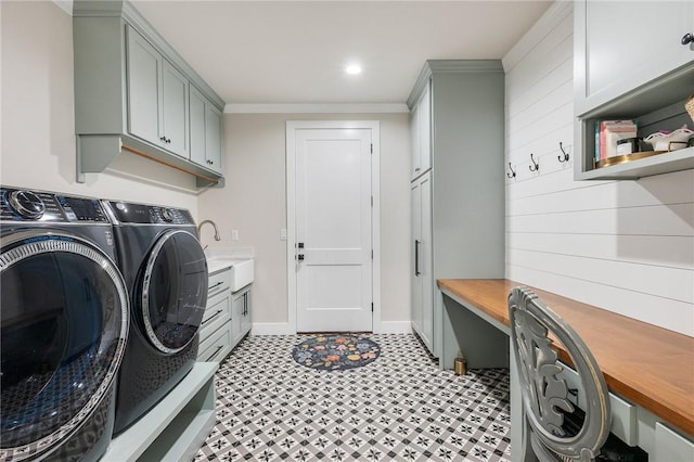 laundry area featuring light floors, washer and dryer, cabinet space, and crown molding
