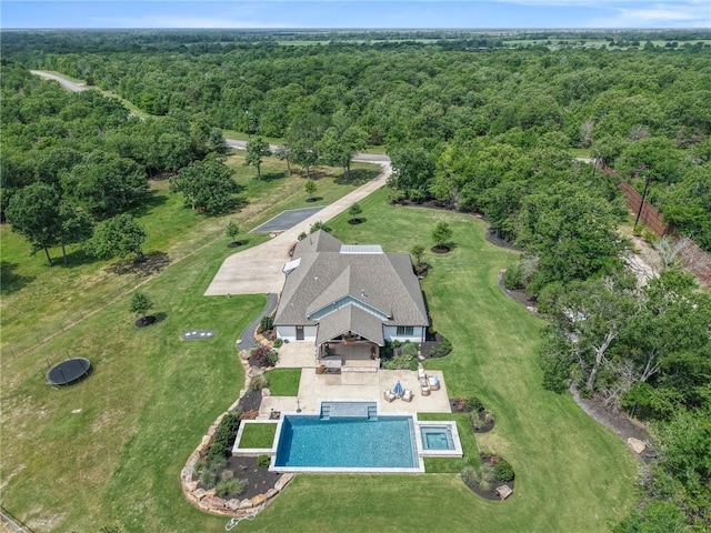 birds eye view of property with a view of trees