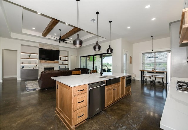 7532 Marys Way, Bryan, TX 77808 - kitchen featuring appliances with stainless steel finishes, a sink, finished concrete flooring, a fireplace, and recessed lighting