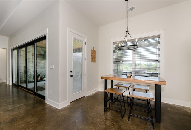 7532 Marys Way, Bryan, TX 77808 - dining room featuring concrete floors, baseboards, and a chandelier