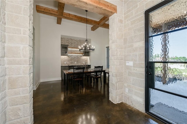 7532 Marys Way, Bryan, TX 77808 - dining room with concrete flooring, beamed ceiling, a chandelier, and baseboards
